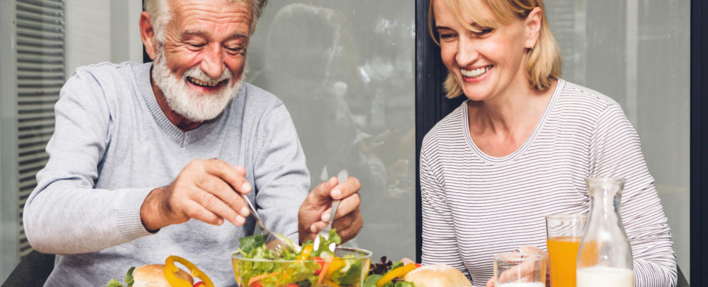 Older man and woman eating a salad